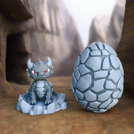Gray dragon figurine and egg on a wooden surface