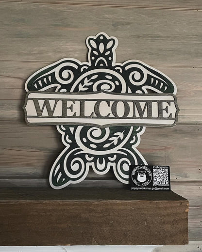 Sea turtle welcome sign stained with blue, green and grey shades sitting on a mantel