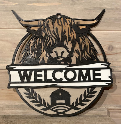 Hyland Cow Welcome sign on display on a fireplace mantel