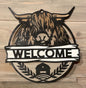 Hyland Cow Welcome sign on display on a fireplace mantel