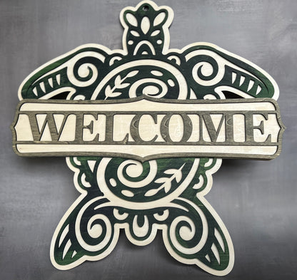 Sea turtle welcome sign stained with blue, green and grey shades with a grey background