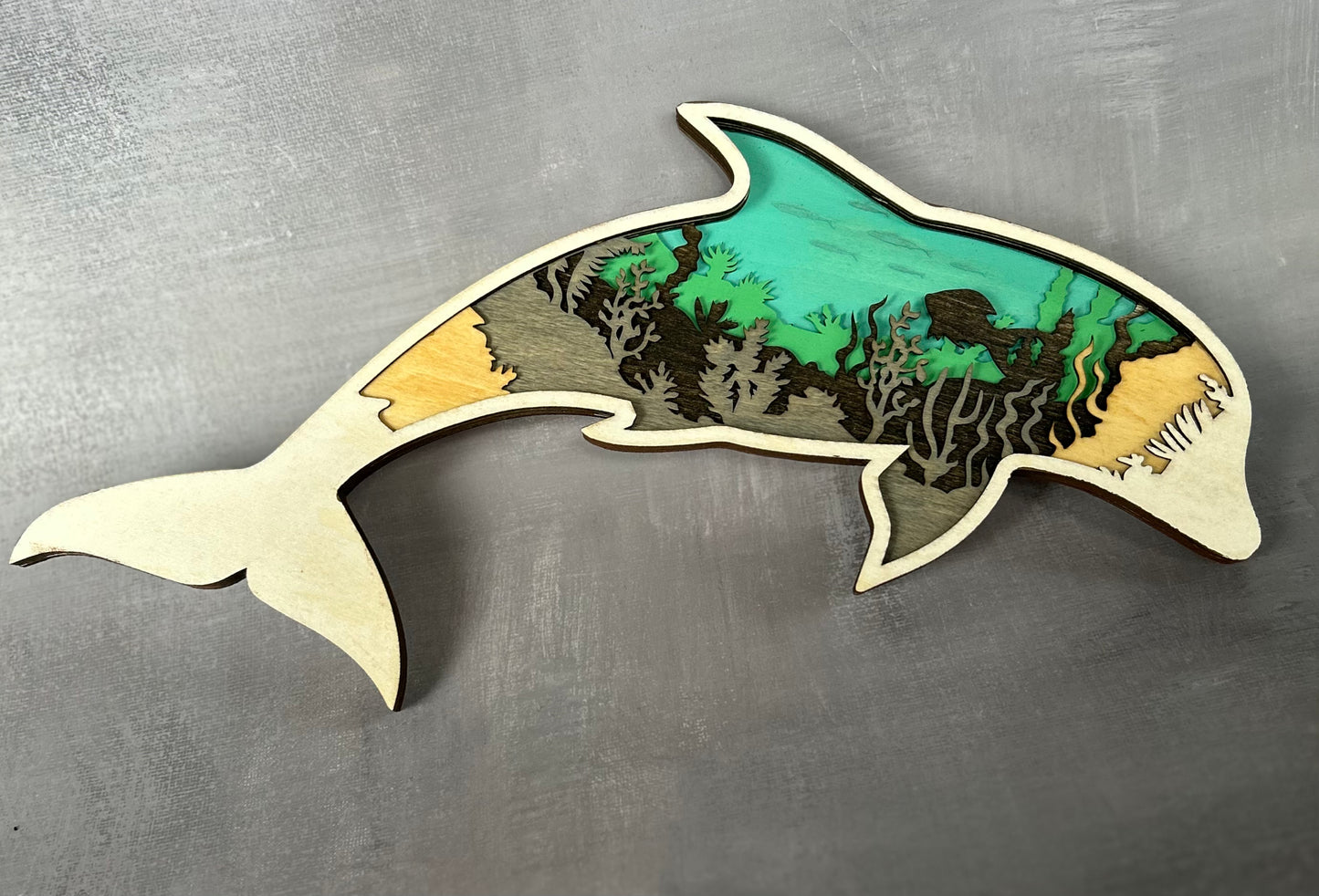 Dolphin made with six laser cut layers painted to create an amazing undersea scene.