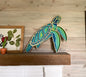 Colorful Sea Turtle, multi-layer, laser cut on fireplace mantel