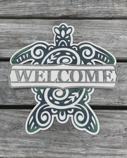 Sea turtle welcome sign stained with blue, green and grey shades with a plank background