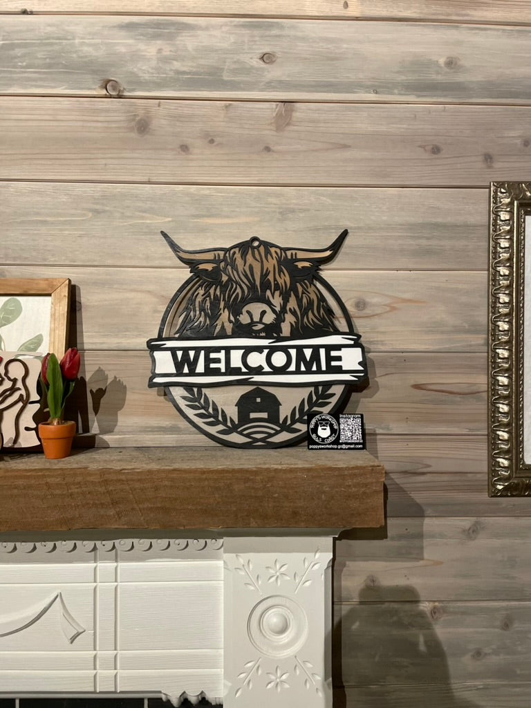 Hyland Cow Welcome sign sitting on fireplace mantel