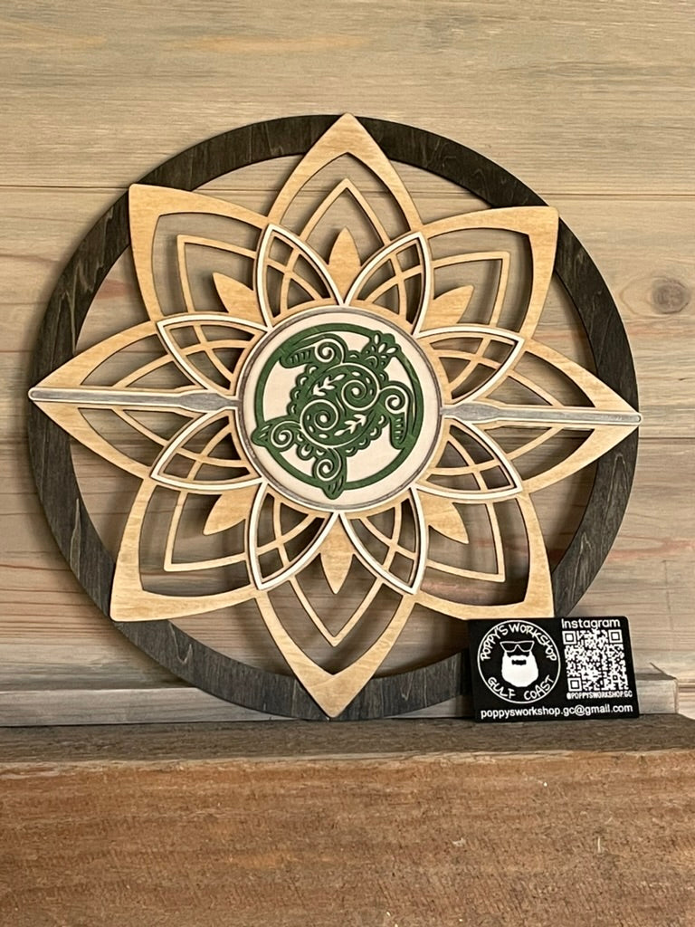 Round flower wall art with sea turtle sitting on fireplace mantel