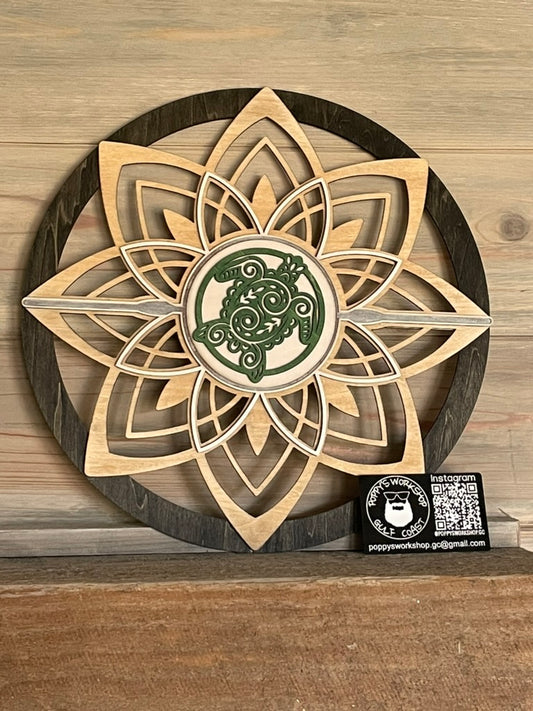 Round flower wall art with sea turtle sitting on fireplace mantel