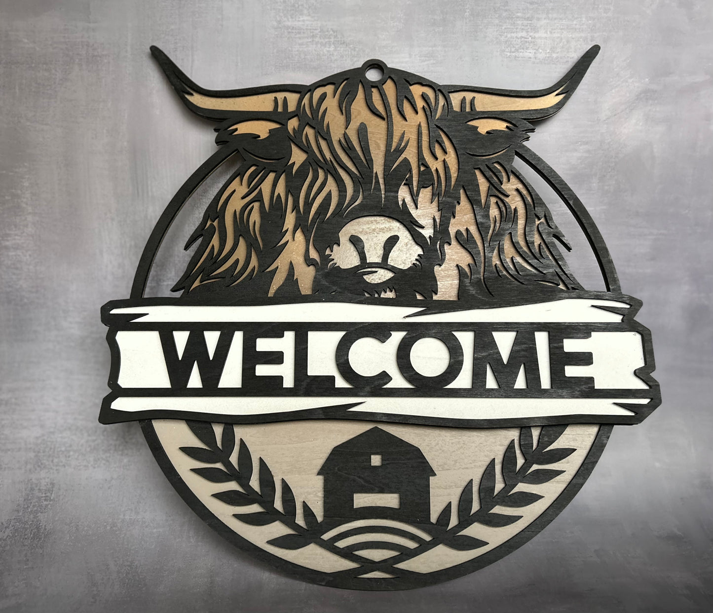 Hyland Cow Welcome sign with grey background