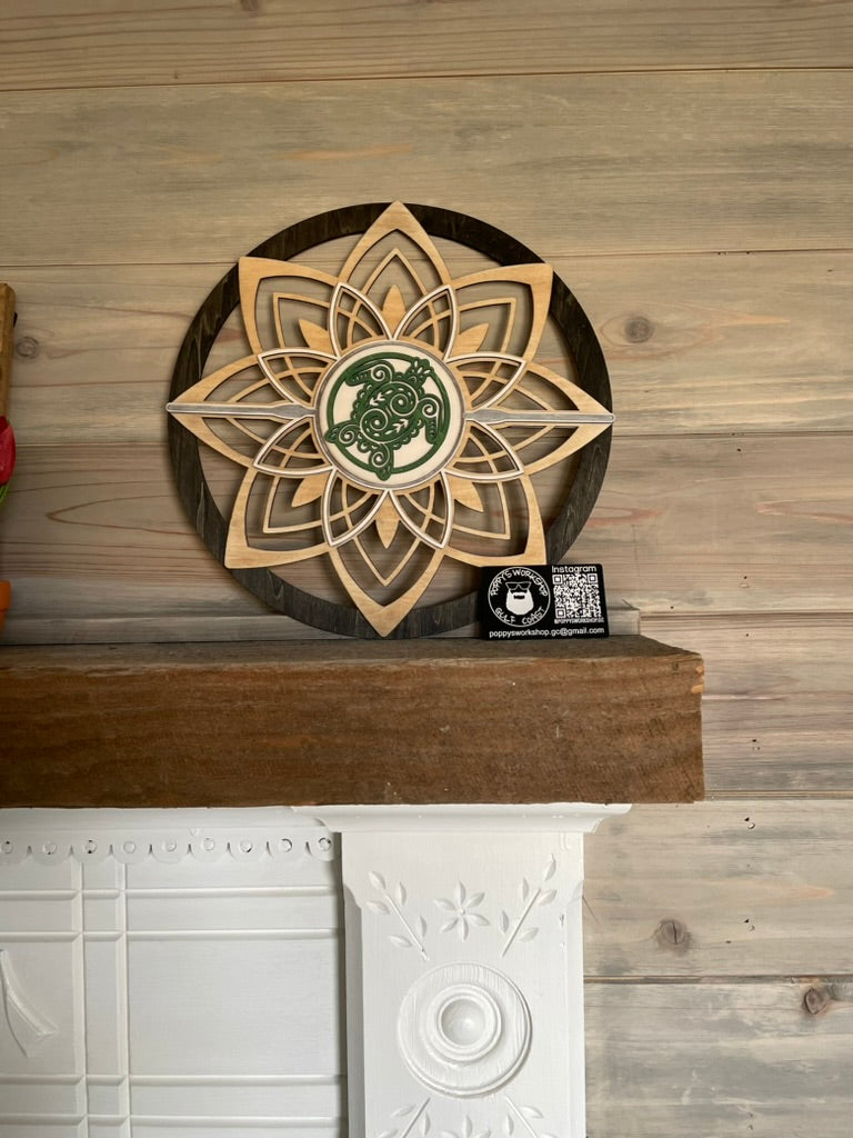 Round flower wall art with sea turtle sitting on fireplace mantel