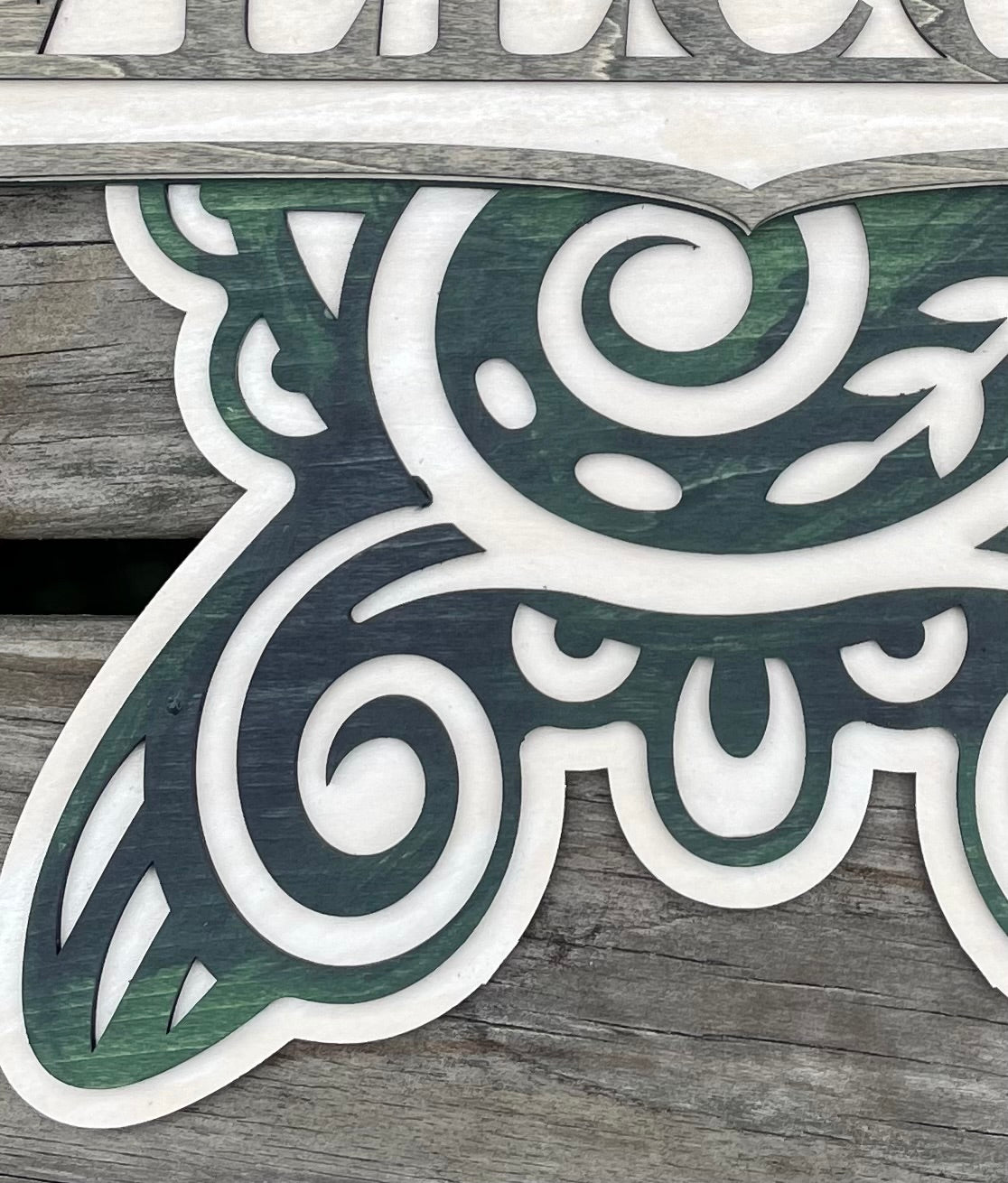 Sea turtle welcome sign stained with blue, green and grey shades close up