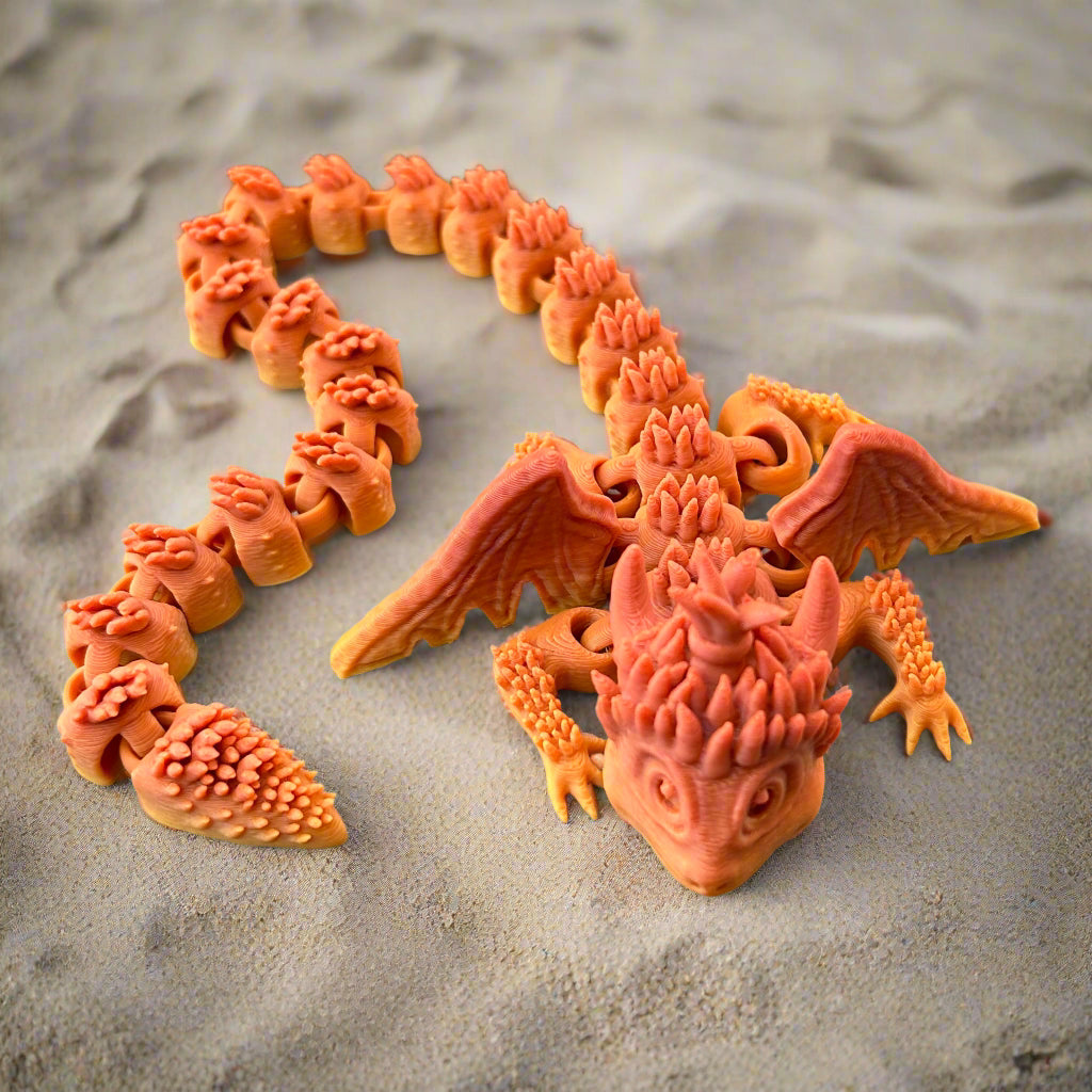 Orange Dragon sitting on sand