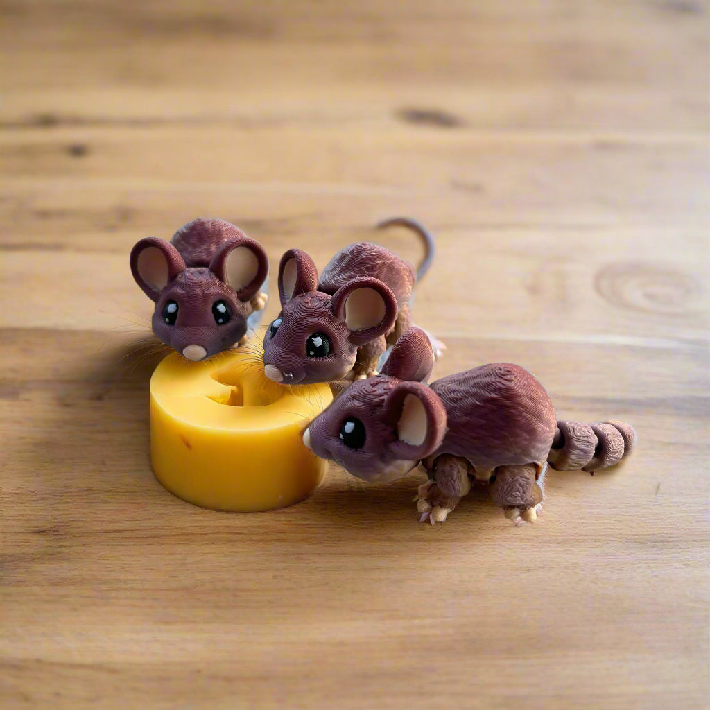 Three mice nibbling on cheese